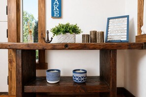 A wooden shelf with two blue and white patterned bowls, a potted plant, and a framed sign with lake rules. - Lake Access Cabin, Walk to Trails + AC & Firepit (Lake Arrowhead)