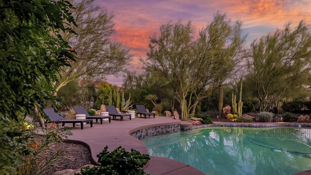 A pool area with lounge chairs and a stone pathway. - Saguaro Sanctuary (Cave Creek)