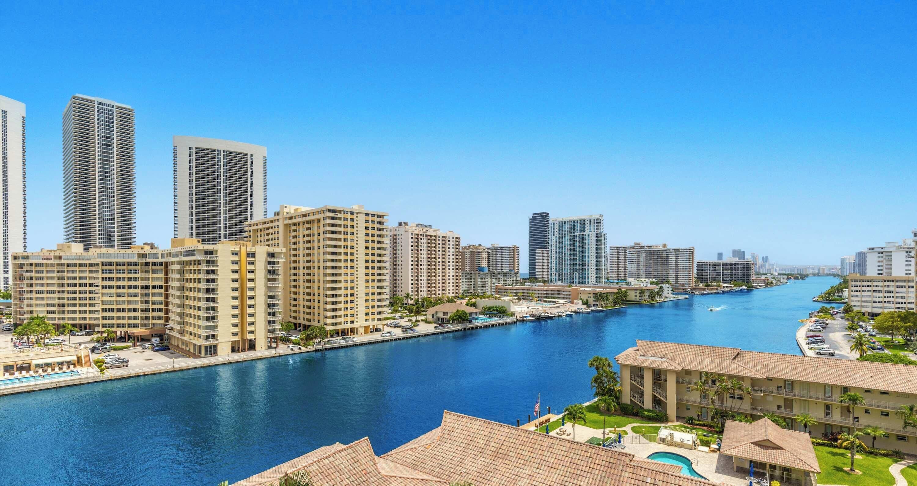 A high-rise hotel with a swimming pool and a marina.