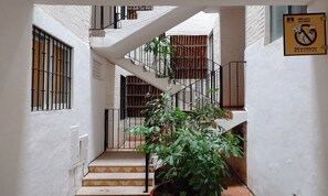 A narrow stairway with a metal railing, leading to a landing with a view of a courtyard. - 2-bedroom apartment in peaceful Puerto Vallarta with AC (Puerto Vallarta)