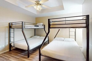 A room with two bunk beds, a ceiling fan, and a skylight. - The Blue House by Whitecap Beach (Corpus Christi)