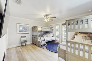 A child's bedroom with bunk beds, a ceiling fan, a ladder, and a small chair. - Saltwater Solace - Under New Ownership (Rockport)