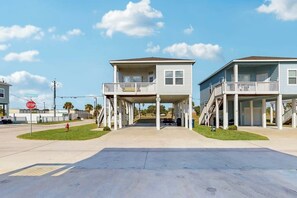 A two-story building with a covered walkway and a stop sign in the foreground. - Sunrise Retreat - Pool, Minutes to Beach & Golf (Rockport)
