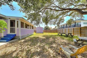 A backyard with a picnic table, a bench, and a small play area. - Sea Grape - Fenced Yard, Central Location (Port Aransas)