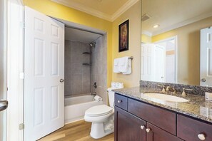 A bathroom with a bathtub, toilet, and sink. - Dawn Condominiums - Break of Dawn (Galveston)