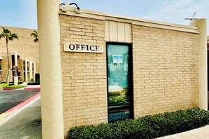 A building with a sign labeled 'OFFICE' on the facade. - The Beach Condo #204 (South Padre Island)