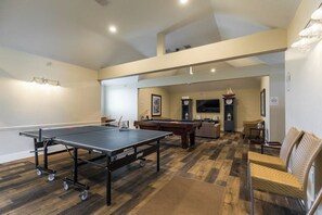 A recreational room with a ping pong table, pool tables, and seating area. - Mannanan Mac Lir - Ocean View, Pool & Hot Tub (Galveston)