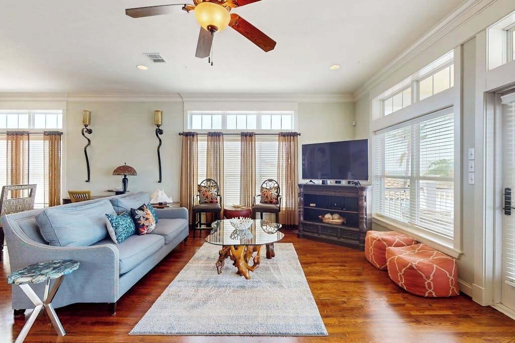 A living room with a sofa, a coffee table, a fireplace, and a television.