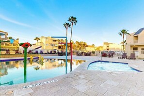 A swimming pool with a no diving sign, lounge chairs, and palm trees. - Solare Garden Villa 679F (South Padre Island)