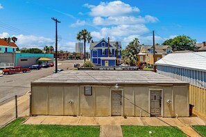 A building with a flat roof, a door, and a window. - Under the Avenue - Near the Beach & The Strand (Galveston)