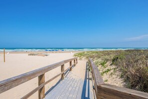 A wooden boardwalk leading to a sandy beach with ocean views. - Sapphire Condominiums Bungalow #106 (South Padre Island)