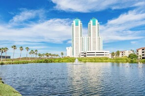 A water body with two high-rise buildings in the background. - Sapphire Condominiums Bungalow #106 (South Padre Island)