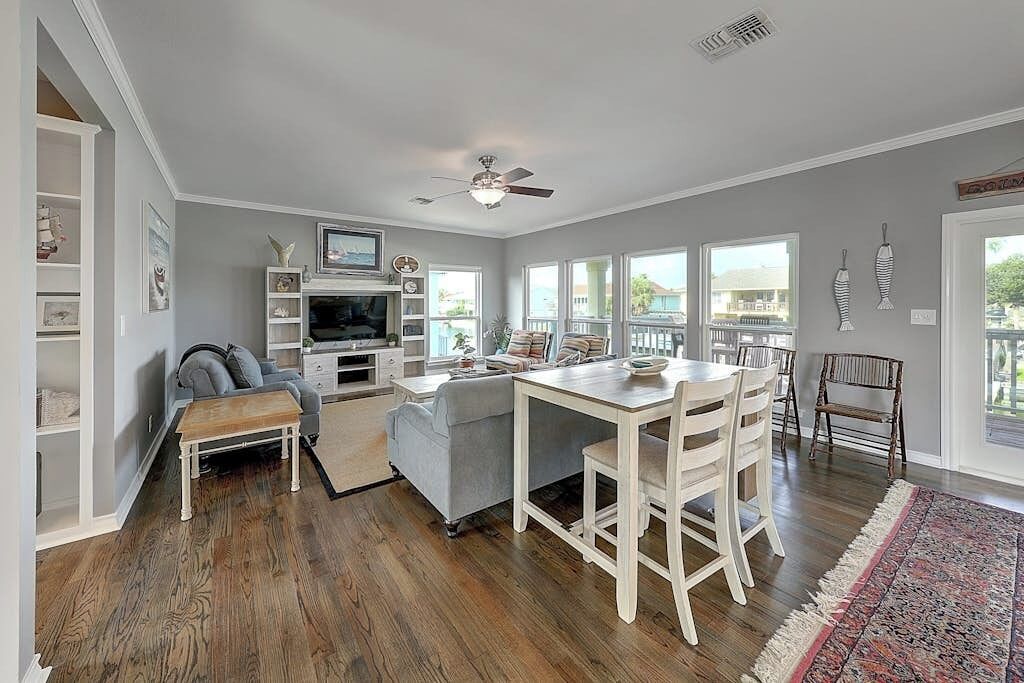 A spacious living area with a fireplace, a dining table, and a sofa.