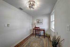 A room with a desk, chair, and a patterned rug. - Curlew Casa - Waterfront, Pool & Dogs OK (Rockport)