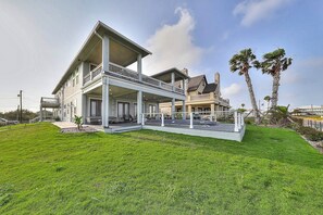 A large, two-story house with a covered porch and a well-maintained lawn. - Inkies Retreat - Waterfront Home with Swim Spa (Rockport)