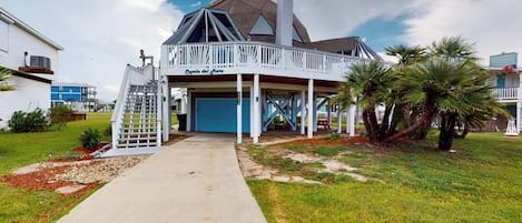 A two-story house with a covered porch and a garage.