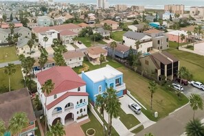 A residential area with houses, some with visible balconies, and a few with attached garages. - Blue Dolphin Beach House (South Padre Island)