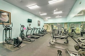 A gym with various exercise equipment, including treadmills, weight machines, and free weights. - Beach Club - Casa Del Sol (Corpus Christi)