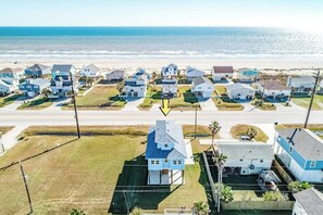 A coastal residential area with houses, a road, and a beach. - Seahorse Beach House (Galveston)