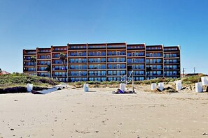 A multi-story hotel with balconies, located on a sandy beach. - Suntide II Condominiums #106 (South Padre Island)