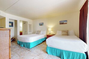 A hotel room with two beds, a desk, and a chair. - Marlin Arms Condominiums #10 (South Padre Island)