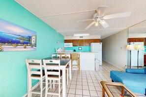A compact living space with a kitchenette, dining area, and a sofa. - Florence Condominiums #707 (South Padre Island)