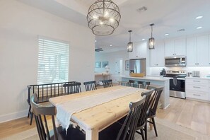 A modern kitchen with white cabinets, stainless steel appliances, and pendant lighting. - A Sea Es La Vida - Water Views & Outdoor Kitchen (Rockport)