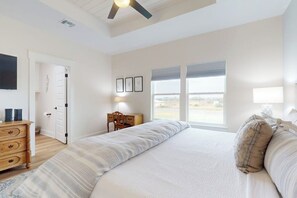A bedroom with a large bed, a desk, a chair, and a window. - A Sea Es La Vida - Water Views & Outdoor Kitchen (Rockport)