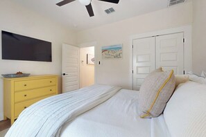 A bedroom with a bed, a ceiling fan, a white wardrobe, and a painting on the wall. - A Sea Es La Vida - Water Views & Outdoor Kitchen (Rockport)