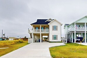 A two-story house with a covered front porch and a second-story balcony. - A Sea Es La Vida - Water Views & Outdoor Kitchen (Rockport)