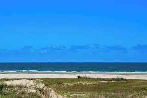 A beach with a clear sky and ocean. - Victorian Condo #9227 (Galveston)