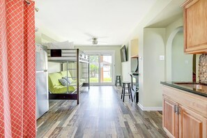 A modern interior with a bunk bed, kitchen area, and a dining space. - The Prescription - Waterfront Dock, Sleeps 12 (Rockport)