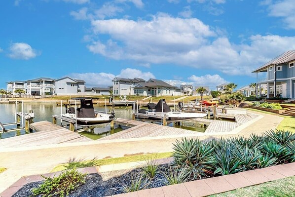 A waterfront residential area with houses, docks, and a marina.