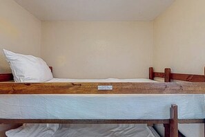 A bunk bed with a mattress and a pillow. - Beachfront Haven - Gulf-Front, Pool & Hot Tub (Galveston)