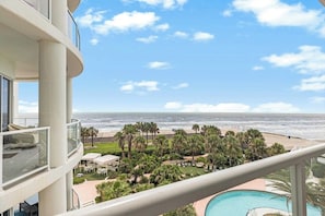A high-rise building with a pool, a beach view, and a clear sky. - Diamond Beach Crown Jewel - #714 (Galveston)