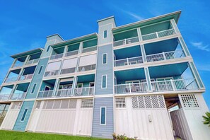 A multi-story building with balconies and a flat roof. - Pointe West Retreat Unit 302 (Galveston)