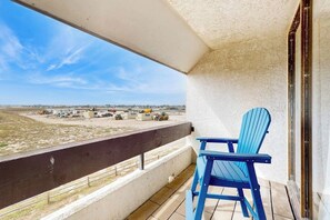 A balcony with a view of a beach and construction site. - Fairway Villa #204 - 2 Balconies, Pool & Hot Tub (Corpus Christi)