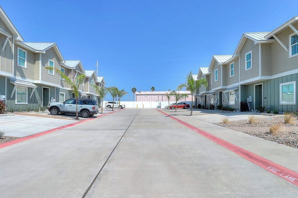 A row of two-story townhouses with a fire lane in the middle.