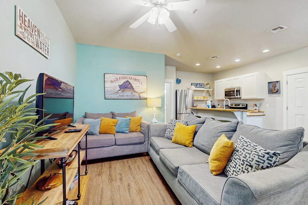 A compact living space with a sofa, a dining table, and a kitchenette.