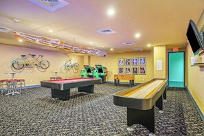 A recreational room with a pool table, bicycles, and a ping pong table. - Diamond Beach Resort - Galveston Gem #514 (Galveston)