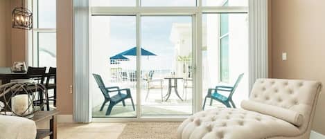 A spacious room with a large sliding glass door leading to an outdoor patio area.