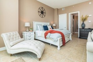 A bedroom with a bed, nightstands, a chair, and a dresser. - Emerald By The Sea #603 (Galveston)