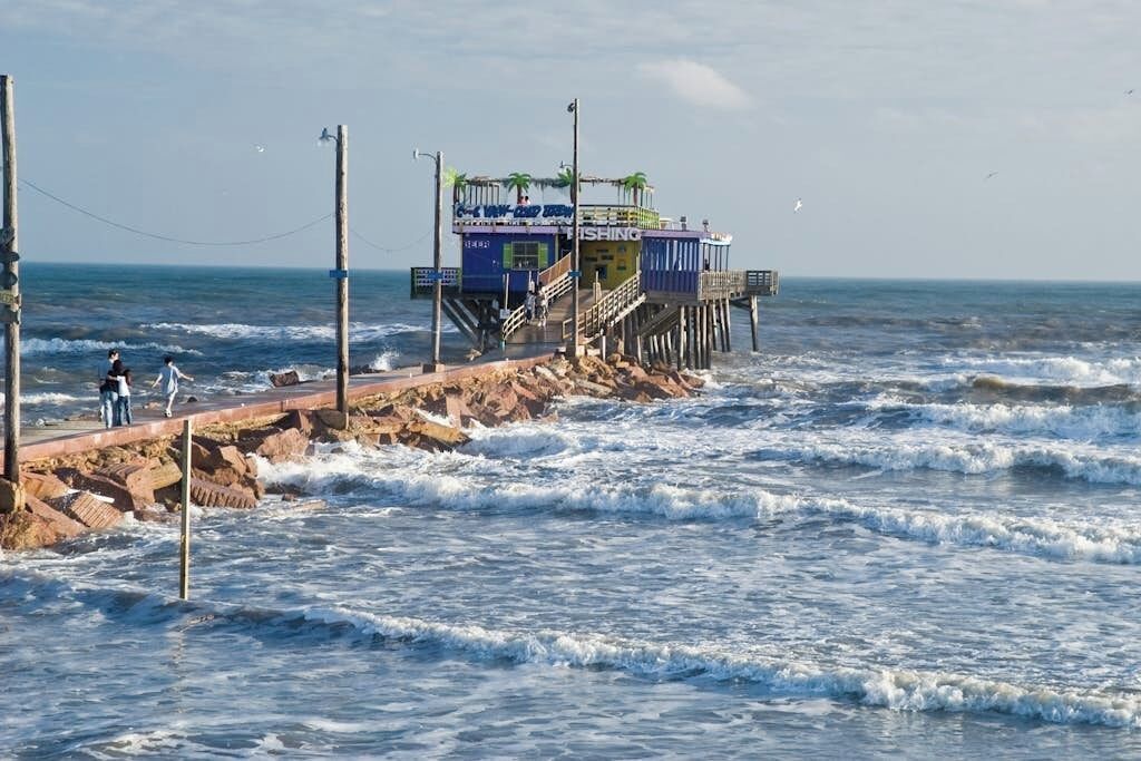 A pier with a building labeled 'FISHING' extending into the ocean.