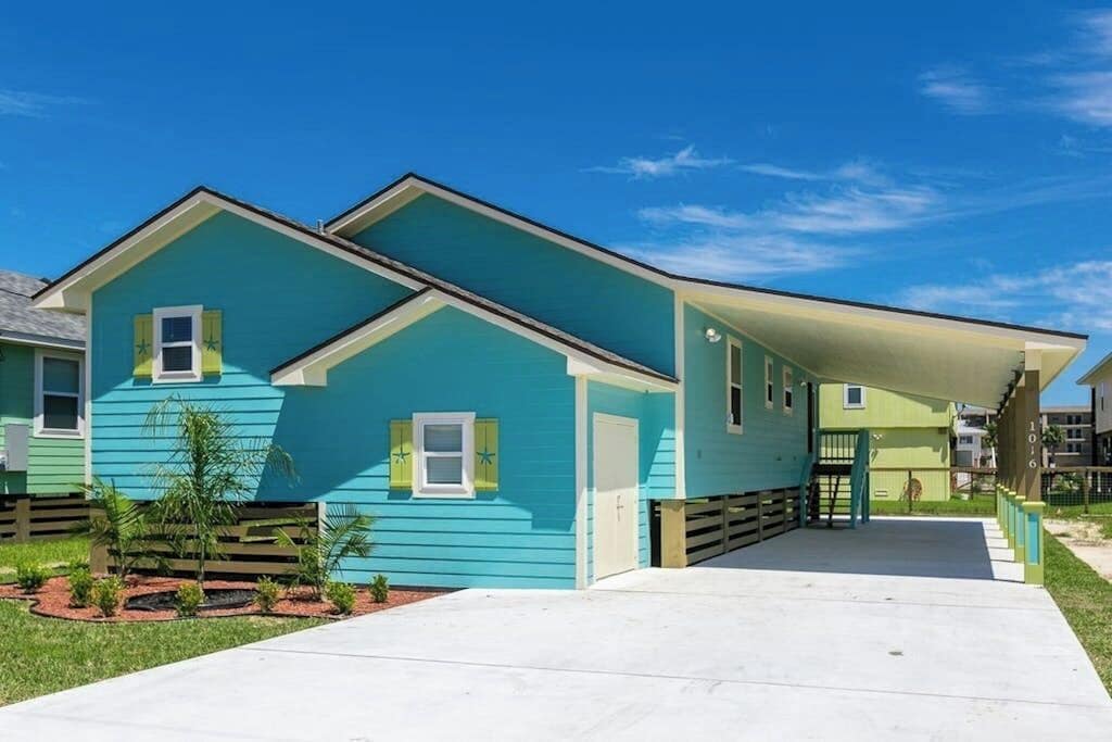 A two-story building with a flat roof and a covered entrance.