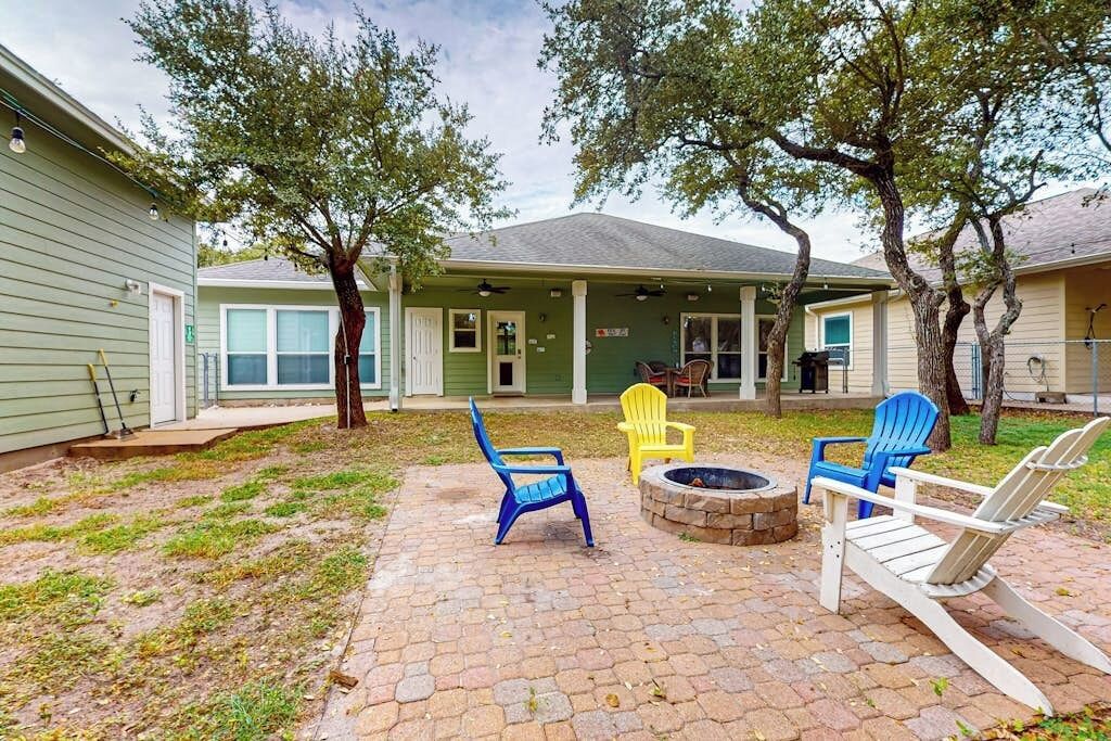 A patio area with outdoor seating and a fire pit.