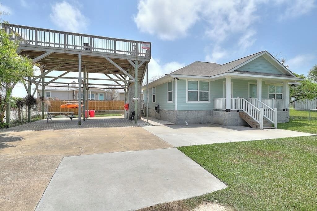 A single-story house with a covered patio area and a front porch.