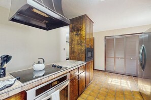 A kitchen with a stove, microwave, cabinets, and a refrigerator. - Harris's Landing - House & Studio, Dog-Friendly (Rockport)
