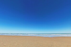A beach with clear skies and calm water. - Suntide II Condominiums #308 (South Padre Island)