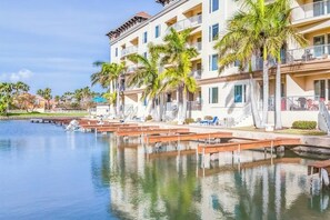 A hotel with balconies, a pool area, and palm trees. - Las Marinas Condominiums 405 (South Padre Island)