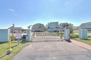A gated entrance to a residential area with a sign reading 'Lost Colony.' - Gulf Beach House #10 (Port Aransas)